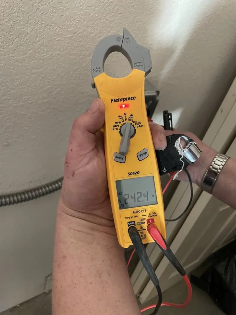 Voltage testing with clamp meter during Electrical Installation Services in Salina